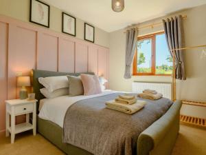 a bedroom with a bed with towels on it at 2 Bed in Llandrindod Wells oc-89064 in Nantmel