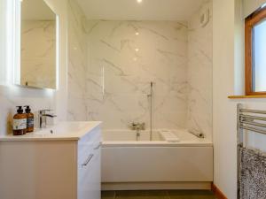 a white bathroom with a tub and a sink at 2 Bed in Llandrindod Wells oc-89064 in Nantmel +18 photos