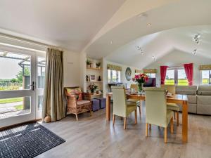 a dining room and living room with a table and chairs at 2 Bed in Derby oc-76519 in Tutbury