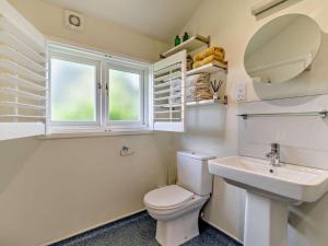 a bathroom with a toilet and a sink and a window at 2 Bed in Derby oc-76519 in Tutbury +30 photos