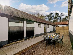 a patio with a table and chairs in front of a house at 3 Bed in Doncaster oc-91307 in Mattersey