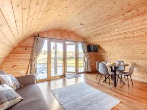 a living room with a couch and a table with chairs at 2 Bed in Rhayader oc-90279 in Saint Harmon