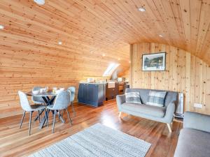 a living room with a table and chairs and wooden walls at 2 Bed in Rhayader oc-90279 in Saint Harmon +13 photos