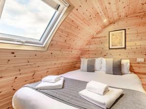 a bed in a wooden room with a window at 2 Bed in Rhayader oc-90279 in Saint Harmon