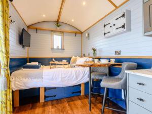 a bedroom with a bed and a desk in a tiny house at 1 Bed in Rhayader oc-90278 in Saint Harmon