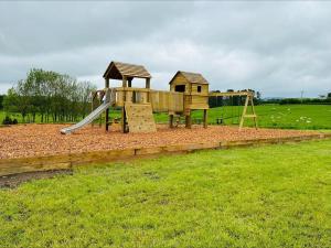 a playground with a slide in a field at 1 Bed in Rhayader oc-90278 in Saint Harmon