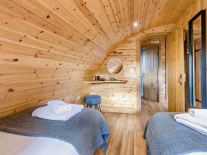 two beds in a room with a wooden ceiling at 2 Bed in Rhayader oc-90276 in Saint Harmon