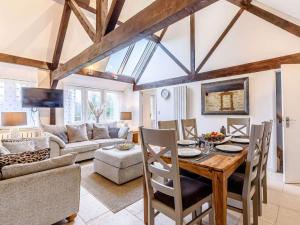 a living room with a table and chairs and a couch at 3 Bed in Chippenham oc-77334 in Chippenham