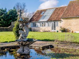 a statue in a pond in front of a house at 3 Bed in Chippenham oc-77334 in Chippenham