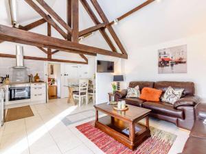 a living room with a leather couch and a table at 2 Bed in Chippenham oc-77333 in Chippenham