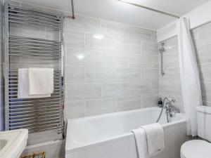 a bathroom with a tub and a toilet and a sink at 2 Bed in Chippenham oc-77333 in Chippenham