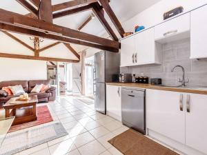 a kitchen and living room with white cabinets at 2 Bed in Chippenham oc-77333 in Chippenham +17 photos