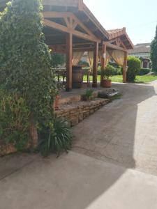 a wooden pergola with a table in a yard at El Campo de Petra in Grado