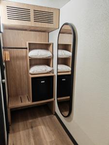 a room with a mirror and a bunk bed at Campanile Lille Sud - Douai Cuincy in Cuincy