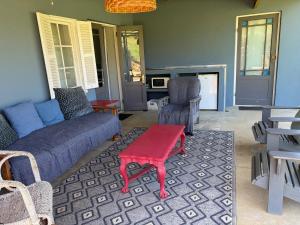 a living room with a couch and a table and chairs at Shabach Farm in Hartebeest Rivier +30 photos