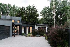 a black house with a driveway at Aspen Lodge Bright in Bright