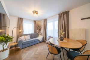 a living room with a blue couch and a table at NORDÉA Apartments in Rostock