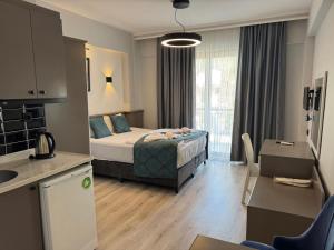 a hotel room with a bed and a kitchen at Orange Garden Aparts & Hotel THE NORDIC in Kemer +57 photos