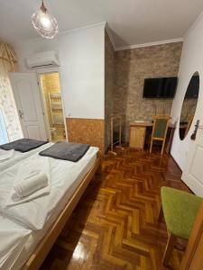 a bedroom with a bed and a desk and a television at Euro Panzio in Debrecen