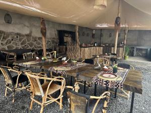 a wooden table with chairs and a tableasteryasteryasteryasteryasteryasteryasteryastery at Meru Nest Arusha in Arusha
