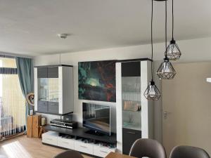 a living room with a flat screen tv and a living room at Sofias Alpenpanorama inkl Aktivcard Bayerischer Wald in Freyung