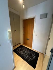 a room with a black rug on the floor next to a door at Cozy studio with a good location in Lappeenranta