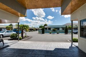 a view of a parking lot at a dealership at Portmans Motor Lodge in Hastings