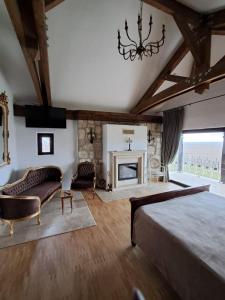 a bedroom with a large bed and a fireplace at CRAMA APOGEUM - Adult only in Gura Vadului