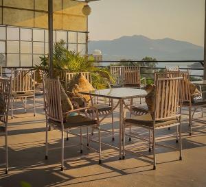 a table and chairs on a patio with a view at Saga by Lake in Udaipur