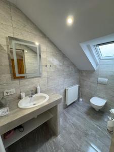 a bathroom with a sink and a toilet at Euro Panzio in Debrecen +66 photos