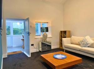 a living room with a couch and a coffee table at The Croft in Ramsey