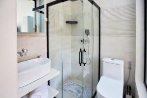 a bathroom with a shower and a toilet and a sink at Tranokely II in Antananarivo