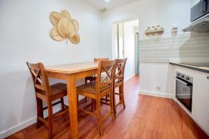 a kitchen with a wooden table and chairs at Tranokely II in Antananarivo +11 photos