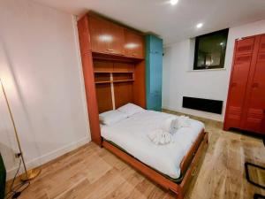 a small bedroom with a bed with white sheets at Milliaux - Bail Partner in Auxerre