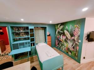 a room with a bed and a painting on the wall at Milliaux - Bail Partner in Auxerre