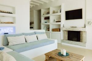 a living room with a couch and a fireplace at Villa Riza in Apróvaton