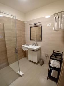 a bathroom with a sink and a shower at Berki Apartman in Körmend