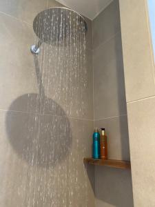 a shower with water pouring from a shower head at Villa Ilios in Paleros +26 photos