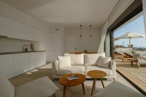 a living room with a white couch and a table at Villa Ilios in Paleros