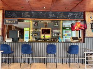 a bar with blue chairs in a restaurant at Orange Garden Aparts & Hotel THE NORDIC in Kemer