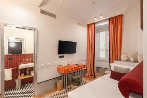 a hotel room with a bed and a television at The Couper Umiltà in Rome