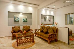 a living room with two couches and a table at Ekostay - Crown Villa in Alibaug