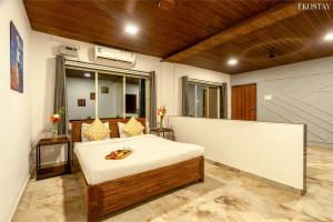 a bedroom with a bed in a room at Ekostay - Crown Villa in Alibaug +12 photos