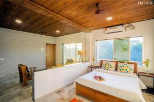 a bedroom with a bed and a large window at Ekostay - Crown Villa in Alibaug