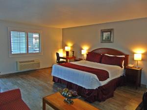 a bedroom with a large bed and a large window at Ramada by Wyndham Kingman in Kingman