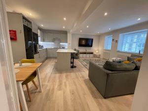 a kitchen and living room with a couch and a table at 1 The Maltings, Crail in Crail