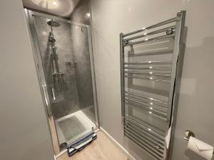 a shower with a glass door in a bathroom at 1 The Maltings, Crail in Crail +25 photos