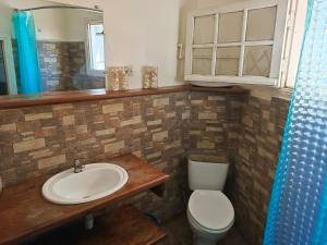 a bathroom with a sink and a toilet and a mirror at La lanterne in Antananarivo +58 photos