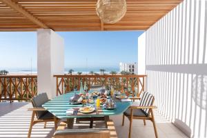a dining table on a balcony with a view of the ocean at The View Agadir in Agadir