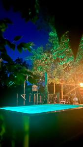 a night view of a swimming pool at night at Eco Cabaña Río con Pileta privada in Tigre